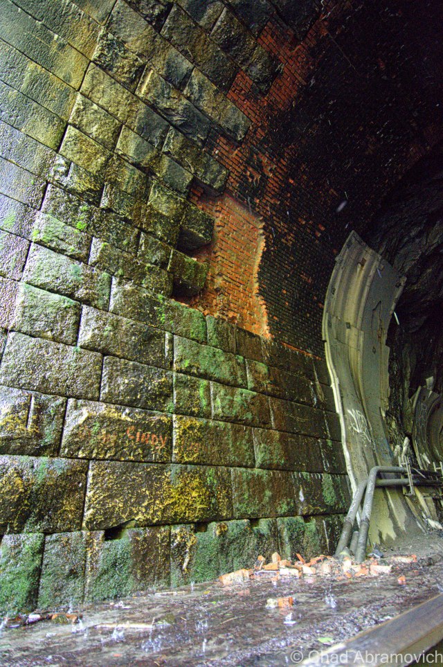 A closer look at the tunnel walls revealed an unnerving scene. The walls were old, and by now, entire sheets of brick were falling at will onto the water logged ground below, a constant shower of icy water, fuel residue and coal dust dripping all over everything. It was an environment that would be very unforgiving if something went wrong.