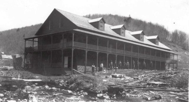 he Loggers Boarding House, and several residents posing for a photograph.